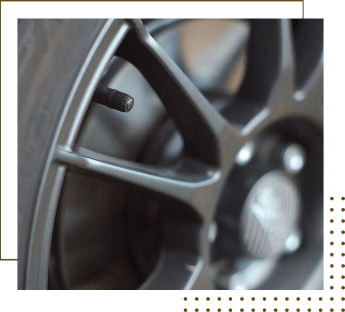 A close up of the rim and tire on a car.