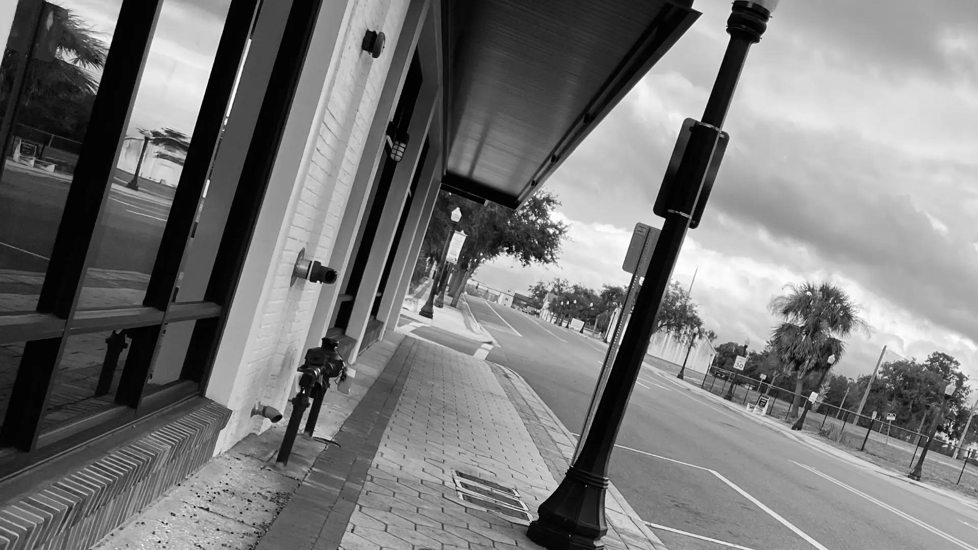 A black and white photo of a street corner.